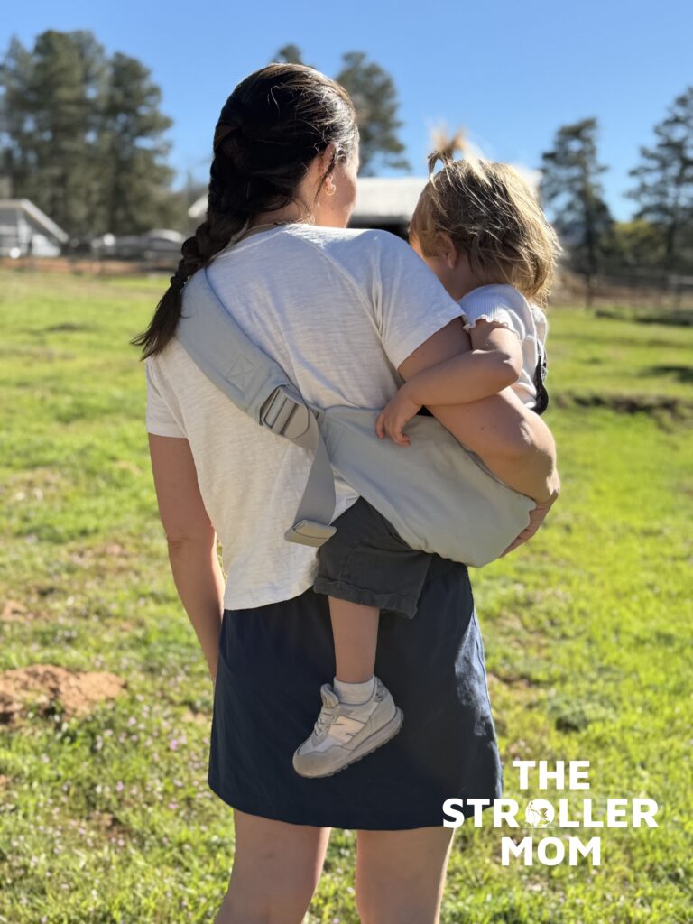 Back view of the Ergobaby Upsie Sling strap lock and adjustable buckle