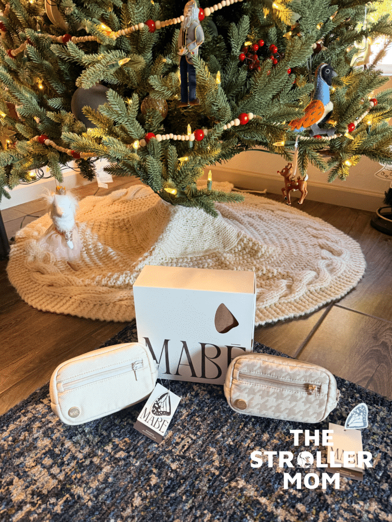 Mabe Monarch Carrier box and two accessory pouches displayed under a Christmas tree — great gift idea for new parents
