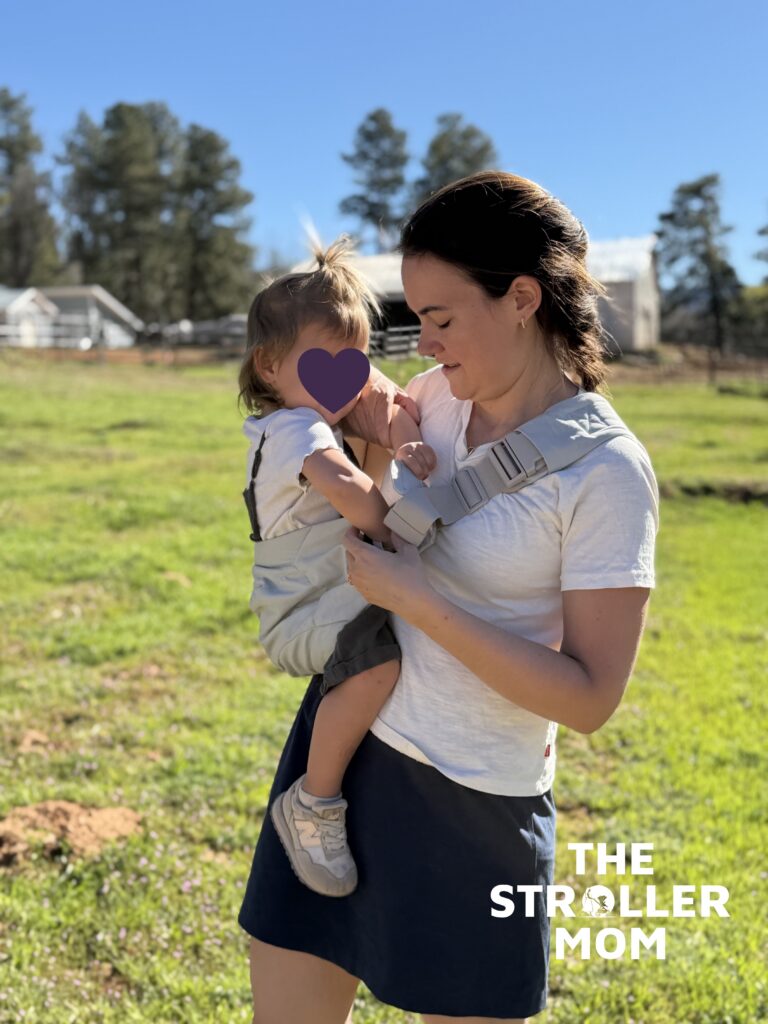 Close-up of the Ergobaby Upsie Sling built-in front pocket with phone and keys inside