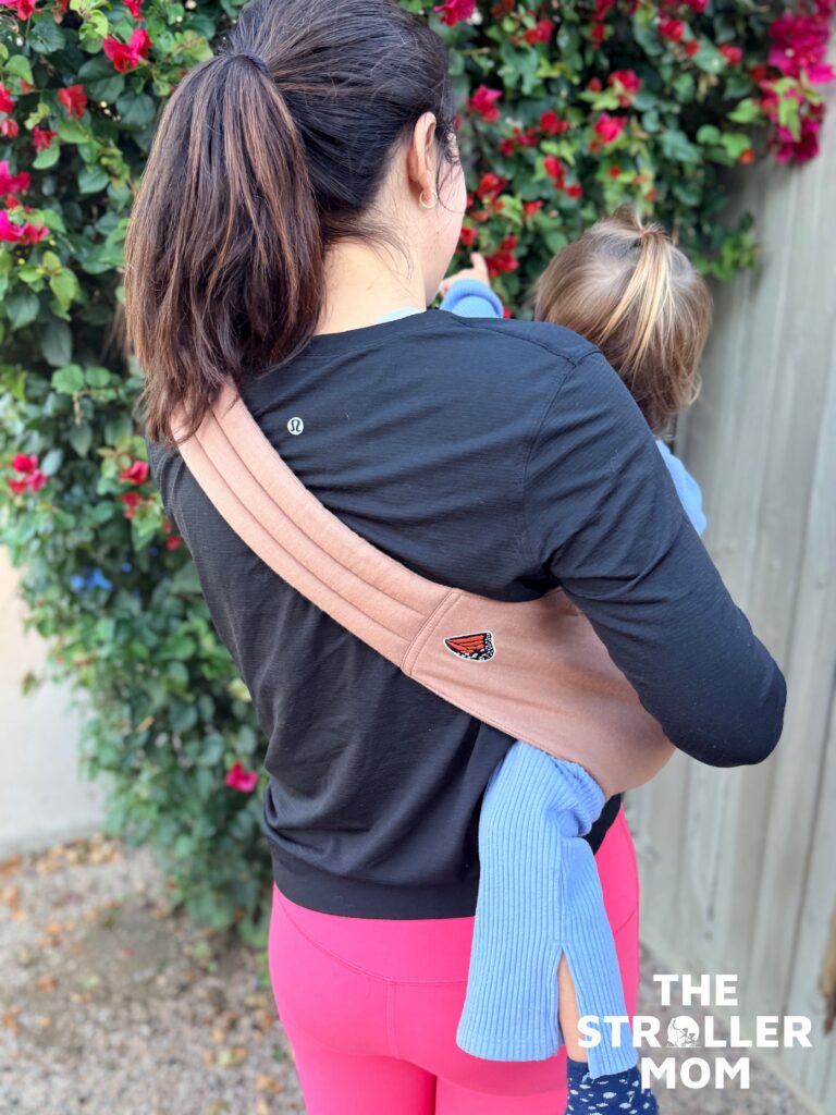 Back view of the Mabe Monarch Toddler Sling showing the padded strap across the shoulder and back