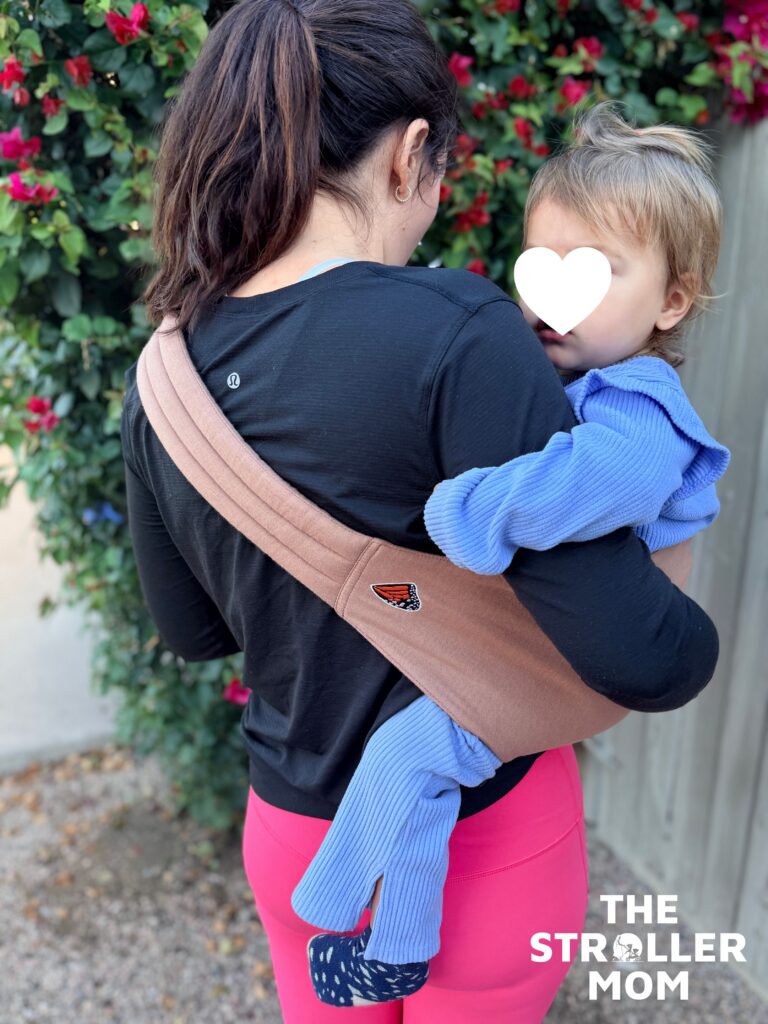 Mabe Monarch Toddler Sling back view with toddler seated on the hip showing how the sling supports the child