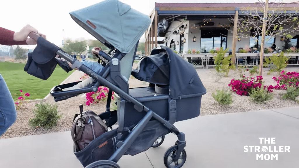 UPPAbaby Vista V3 in double mode with toddler seat and bassinet being pushed outdoors