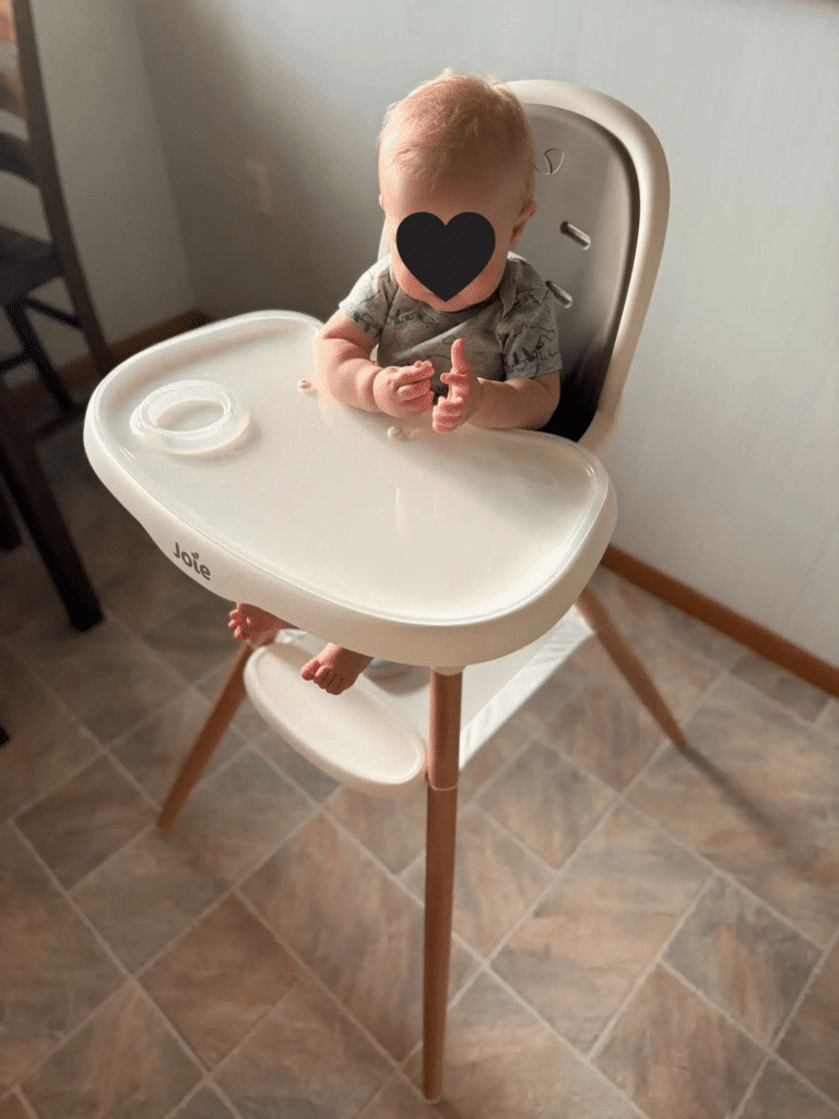Child sitting in the Joie Chai High Chair