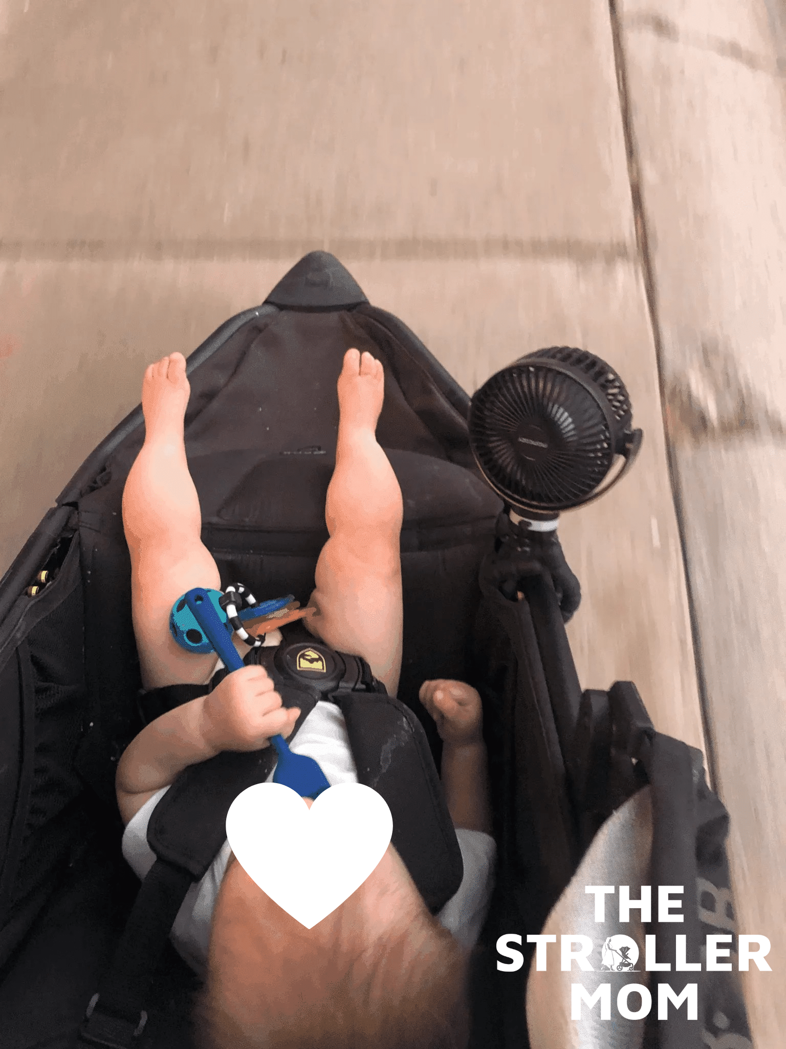Child seated in the BOB Alterrain Pro jogging stroller with face covered