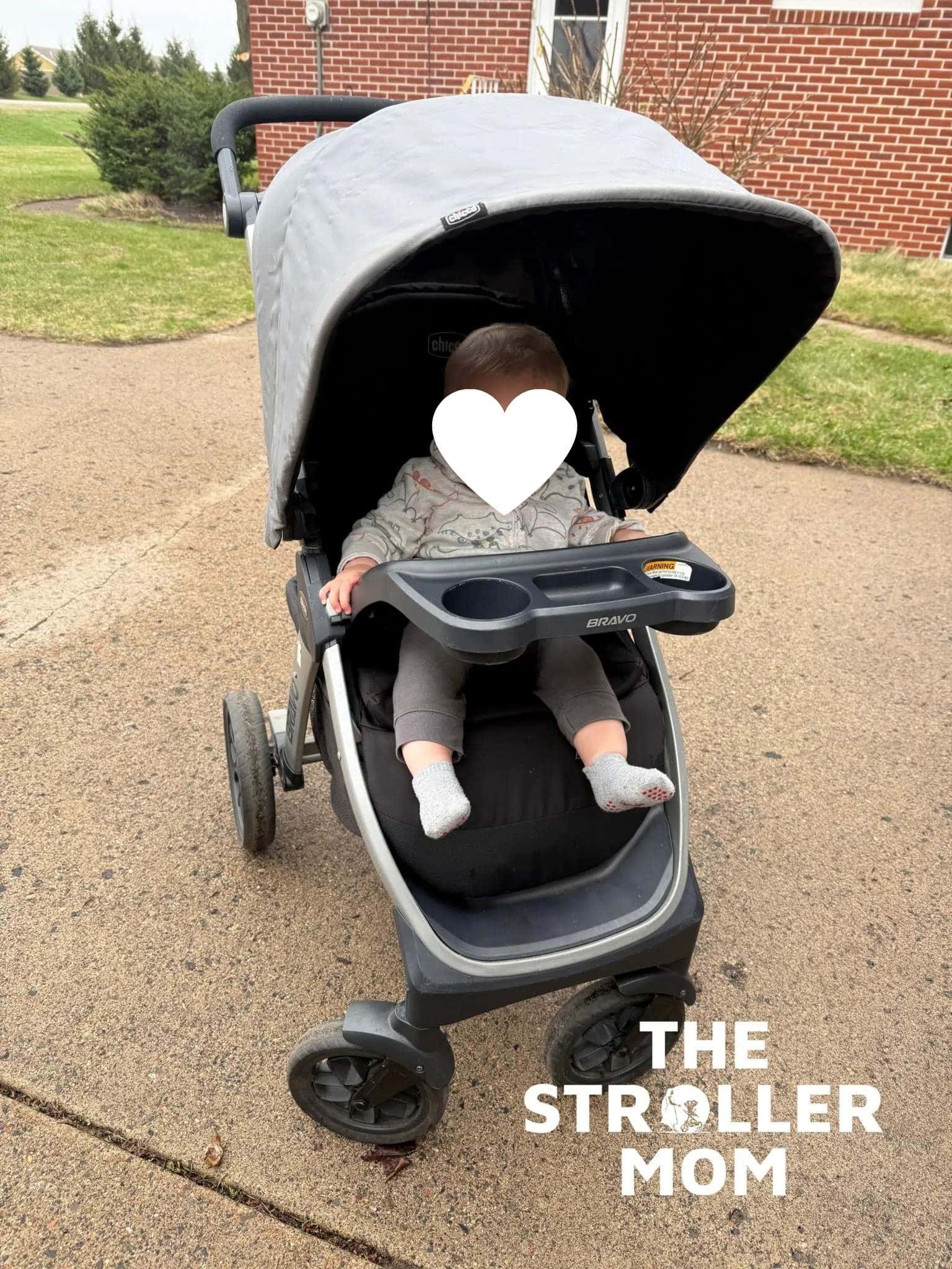 Child seated in the Chicco Bravo with face covered