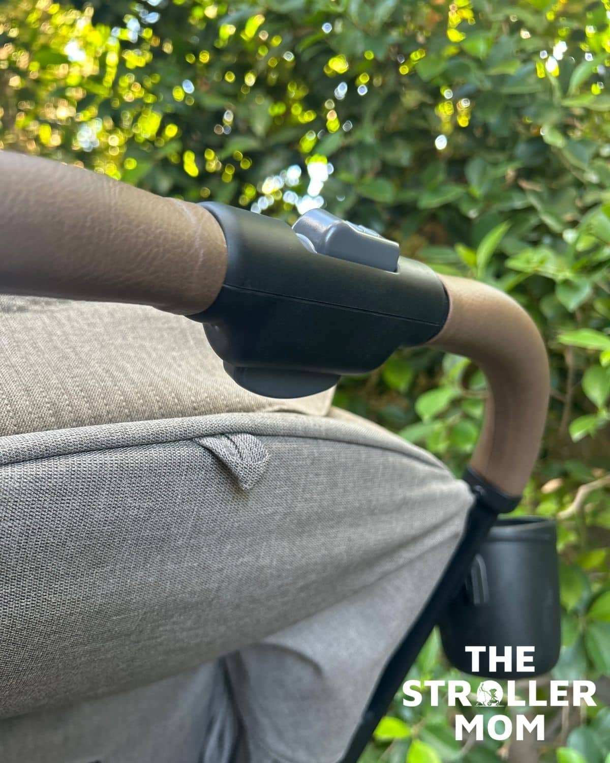 Close-up of the Joie Nutmeg leatherette handlebar and cup holder