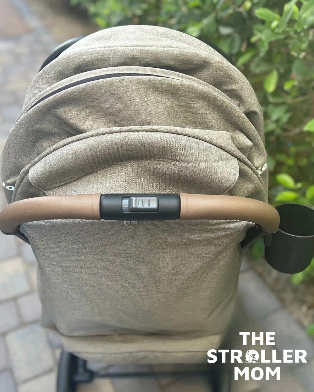 Joie Nutmeg handlebar with the fold button and a cup holder, back view