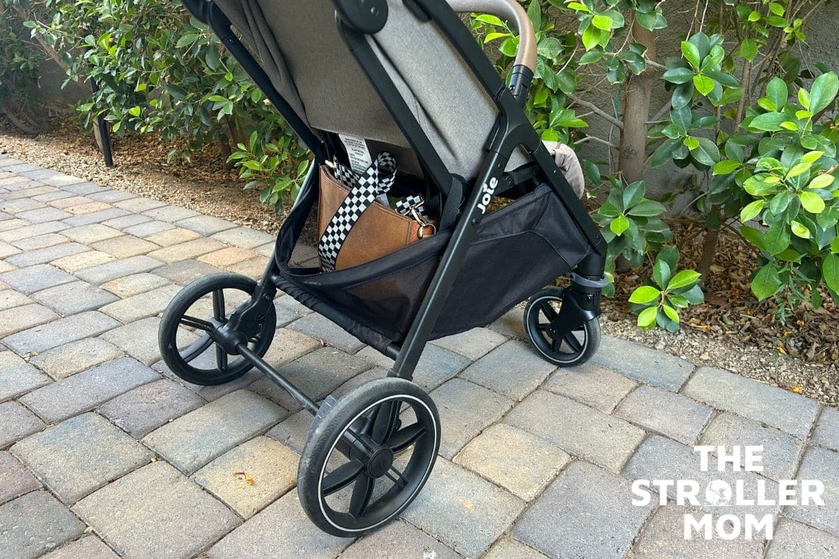 Joie Nutmeg storage basket under the seat, side view