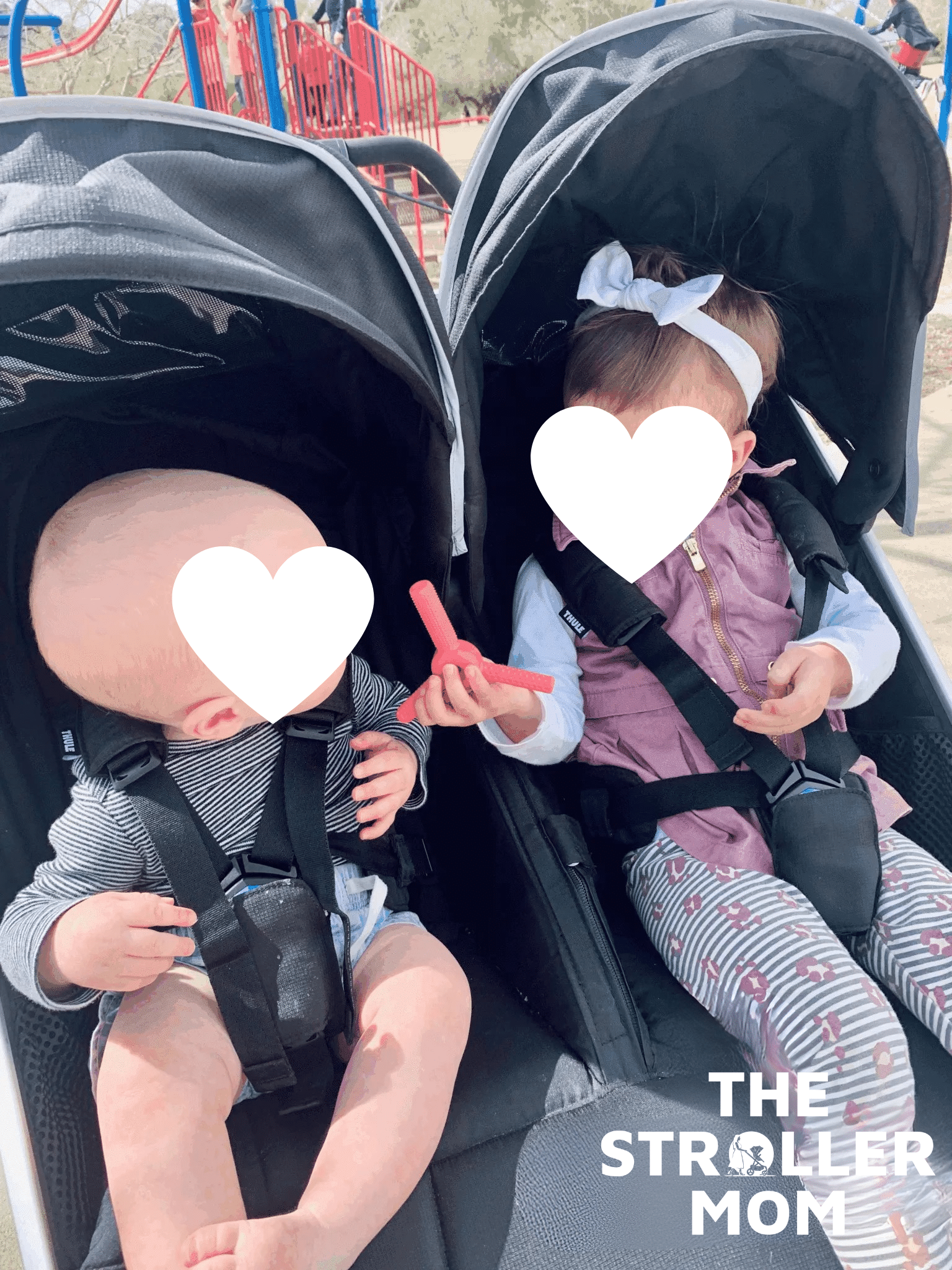 Two children in the Thule Urban Glide 3 Double with faces covered